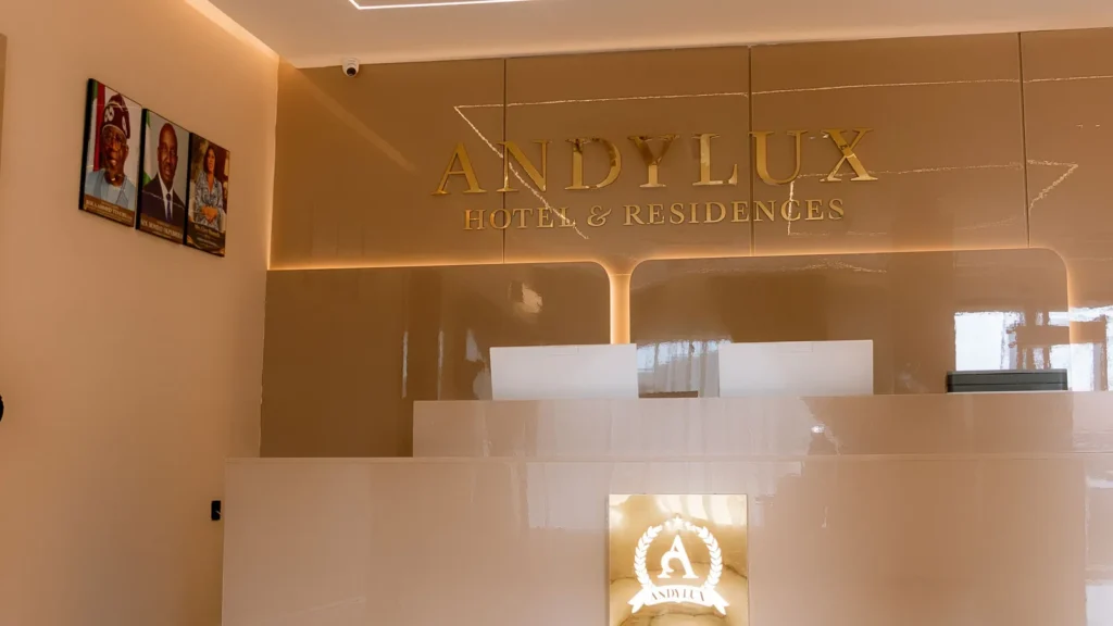 Reception desk with gold Andylux lettering and backlit panels