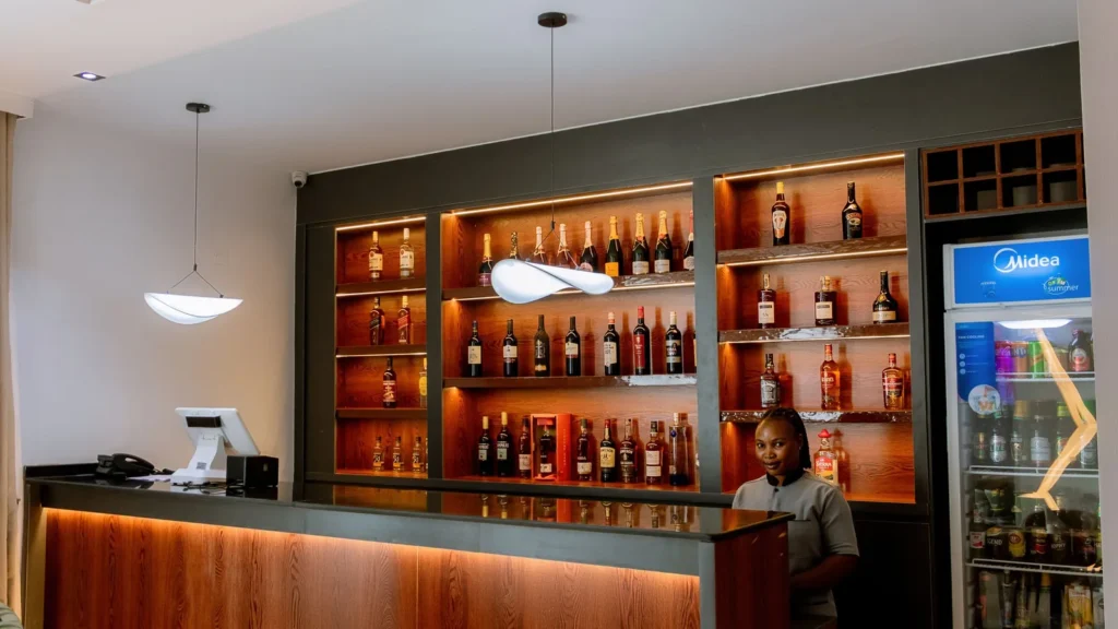 The bar with backlit shelves of wine and spirits